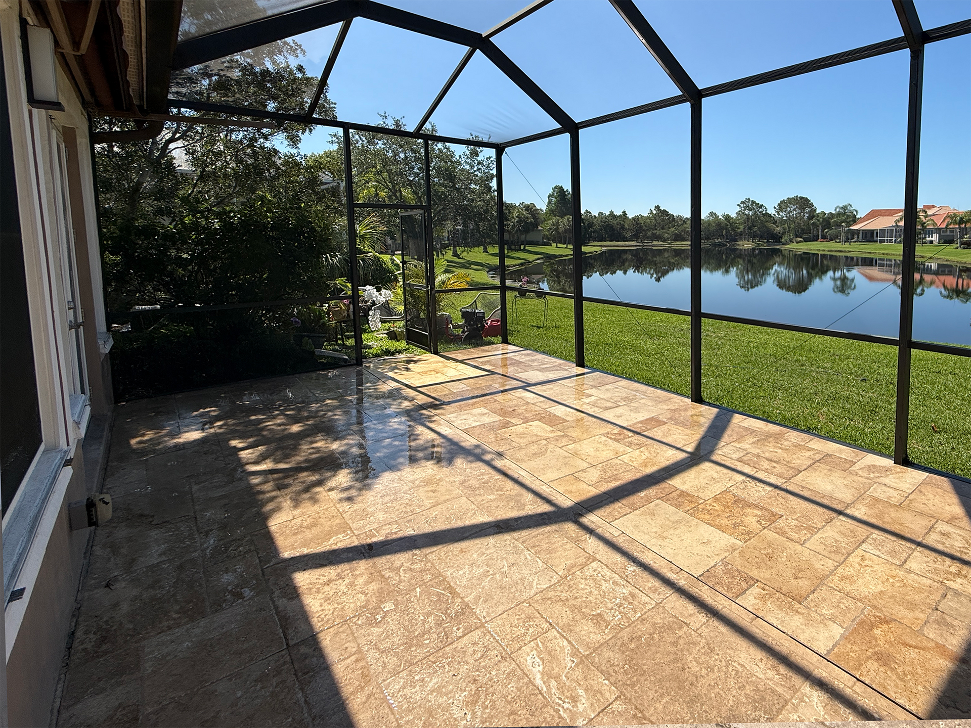 A screened in patio with a view of a lake