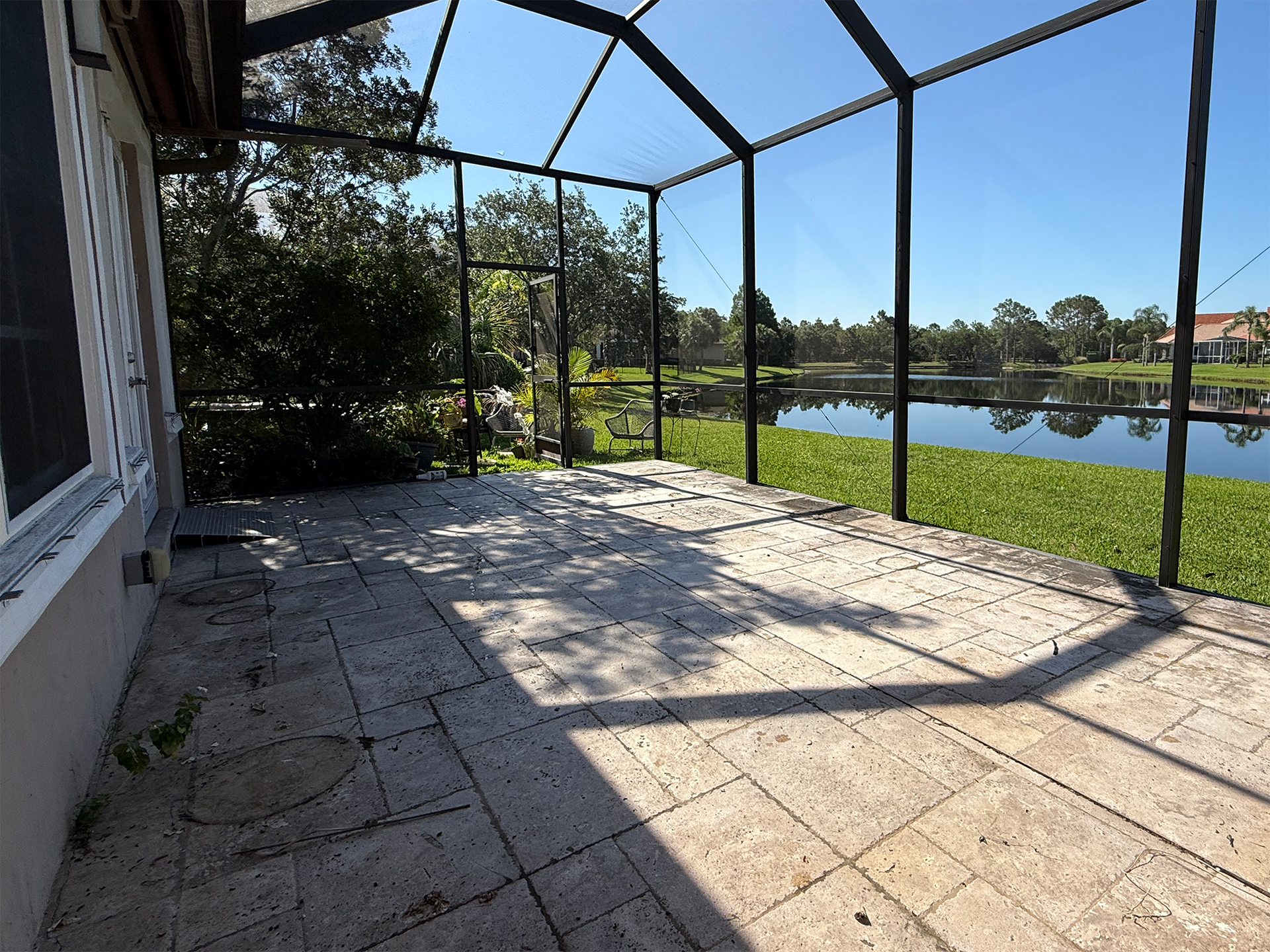 A screened in porch with a view of a lake