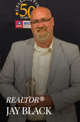 Man in striped jacket, holding award, with 