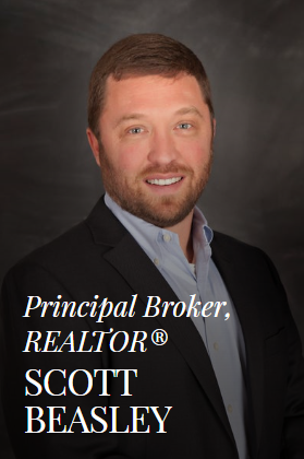 Scott Beasley, real estate broker, smiling in suit jacket and open collar.