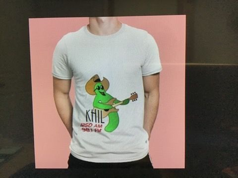 A light-colored t-shirt with a graphic of a green, guitar-playing pickle wearing a cowboy hat and sunglasses.