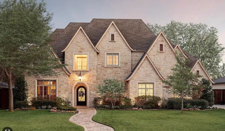 A large brick house with a walkway leading to it