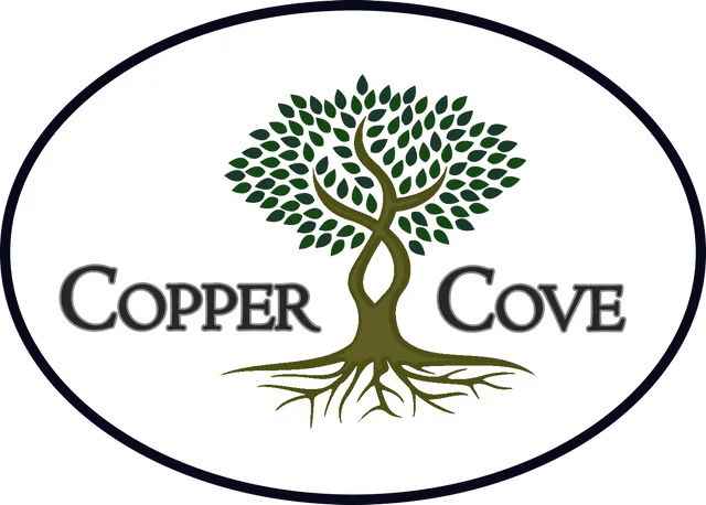 The logo for copper cove is a tree with roots and leaves.