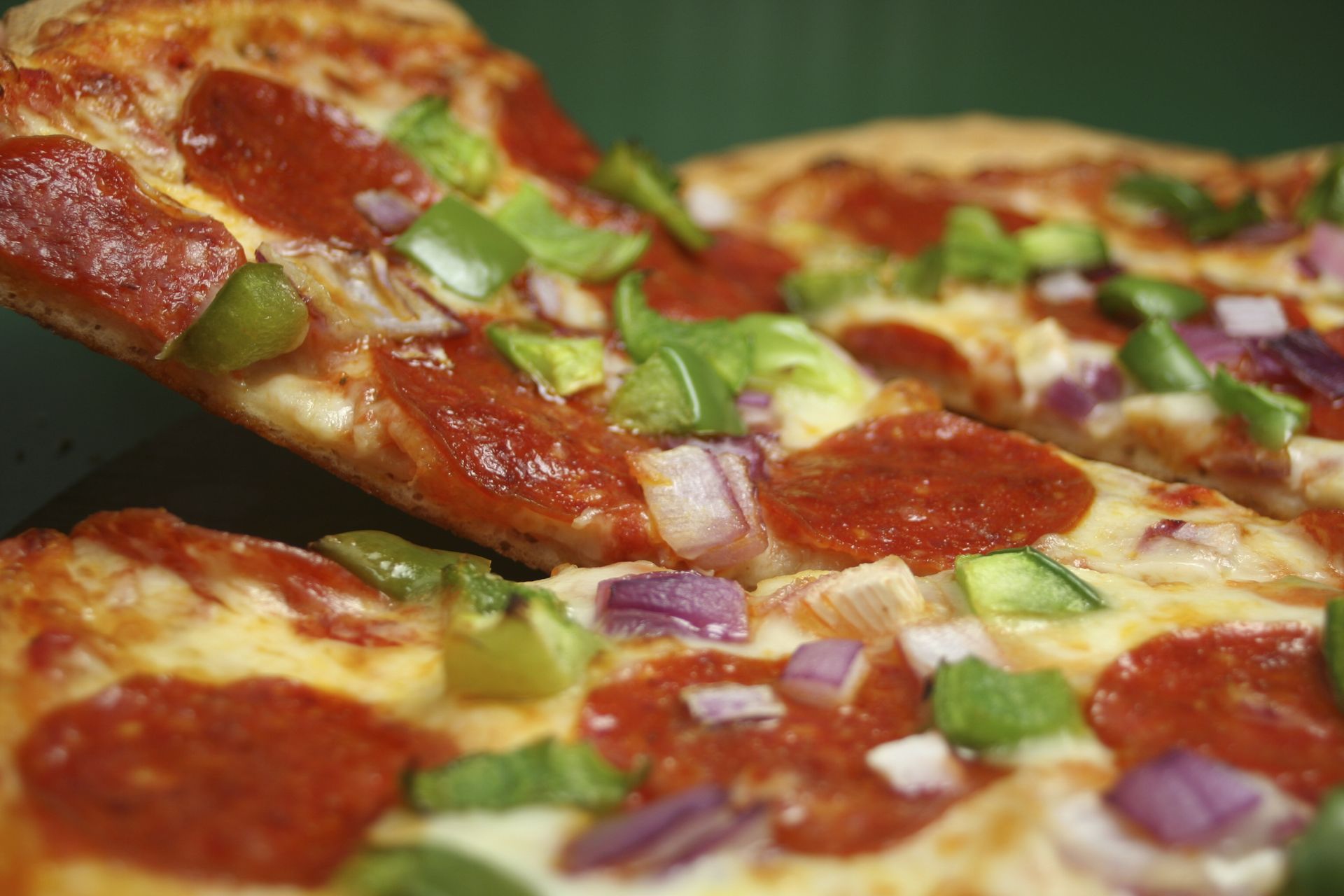 Pizza with pepperoni onions green peppers