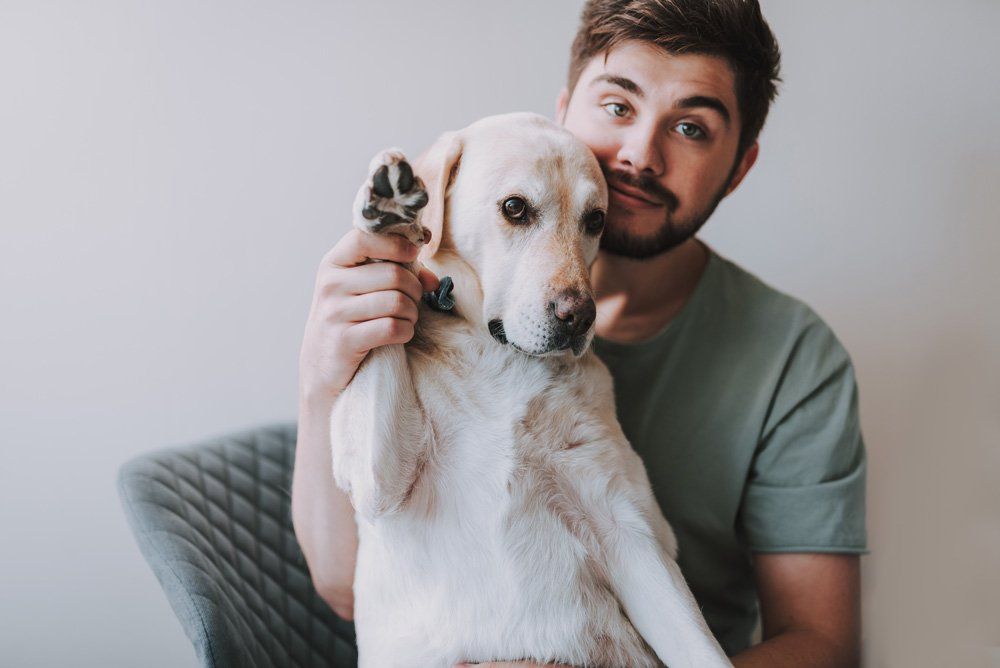 Man with His Dog — Austin, TX — Pet and Bird Clinic