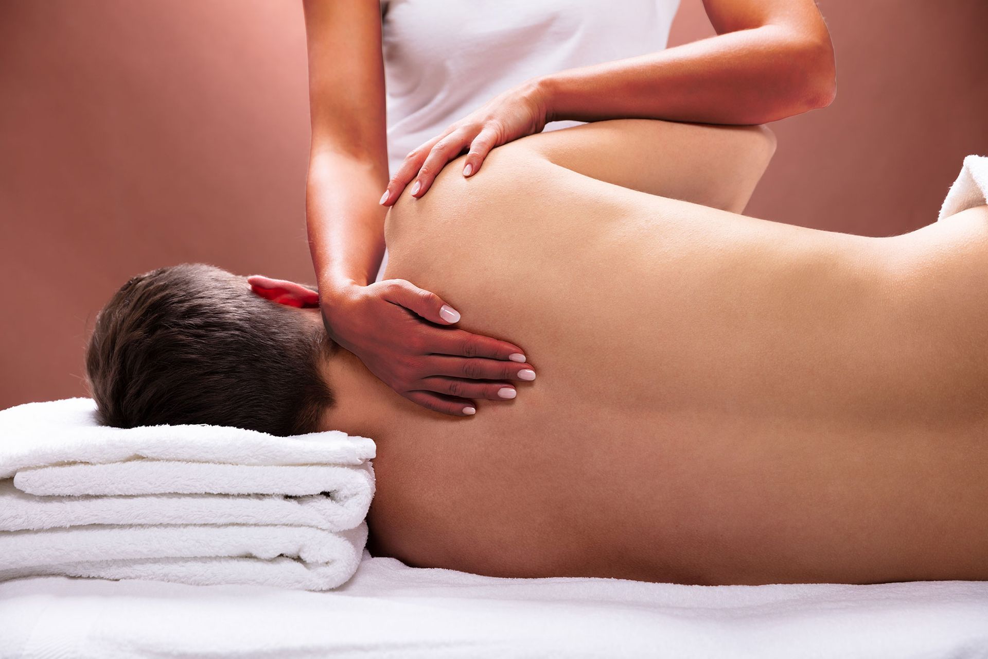 A man is getting a sports massage from a woman