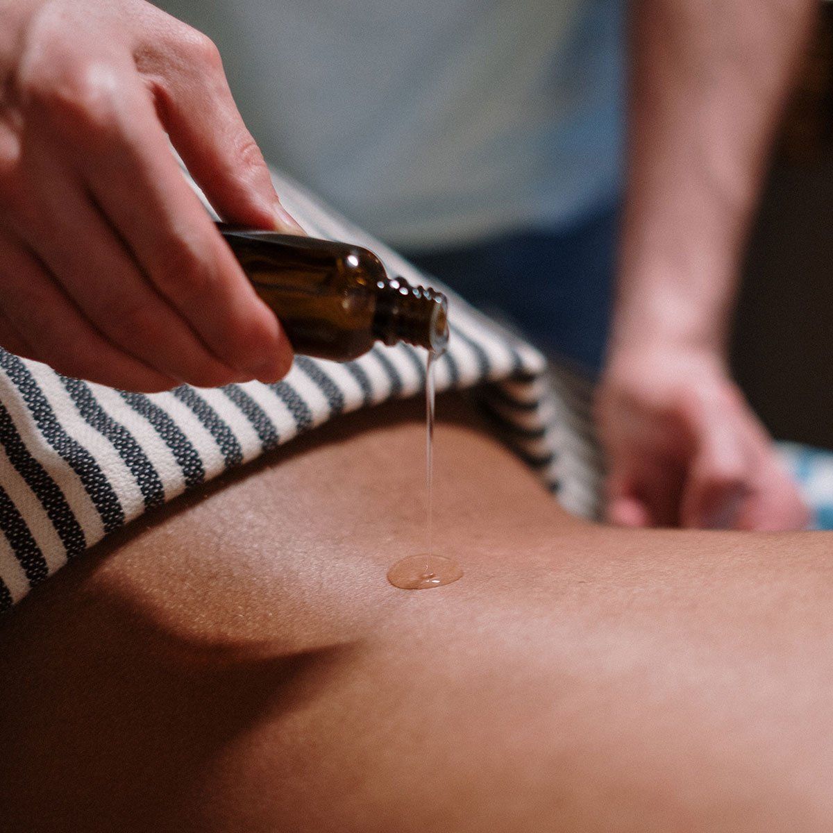 Practitioner performing Young Living Raindrop Technique at Health Energies Vaughan Wellness centre