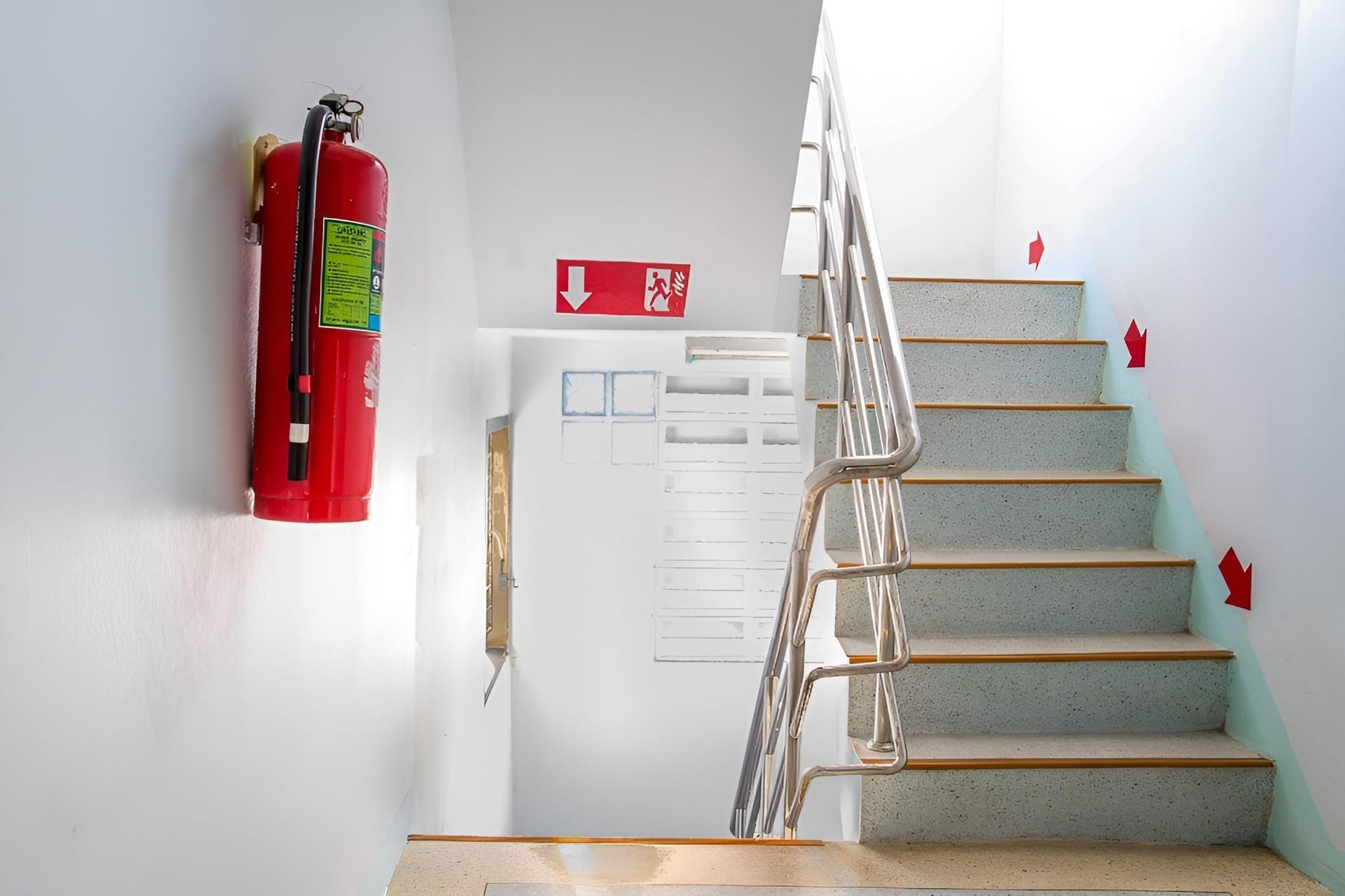A Fire Extinguisher Is Hanging on The Wall Next to A Set of Stairs — Stellar Test and Tag in Gunnedah, NSW