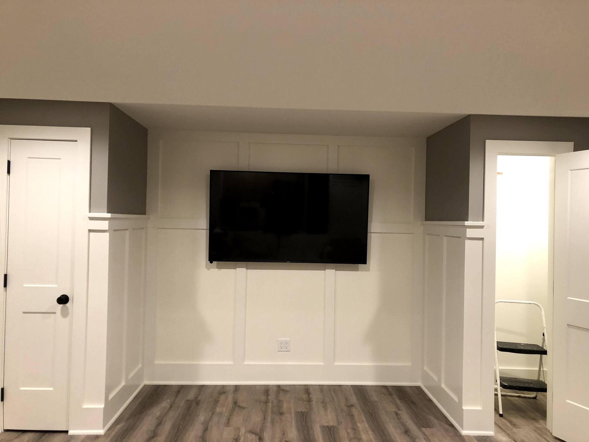 a flat screen tv mounted on a wall in a room