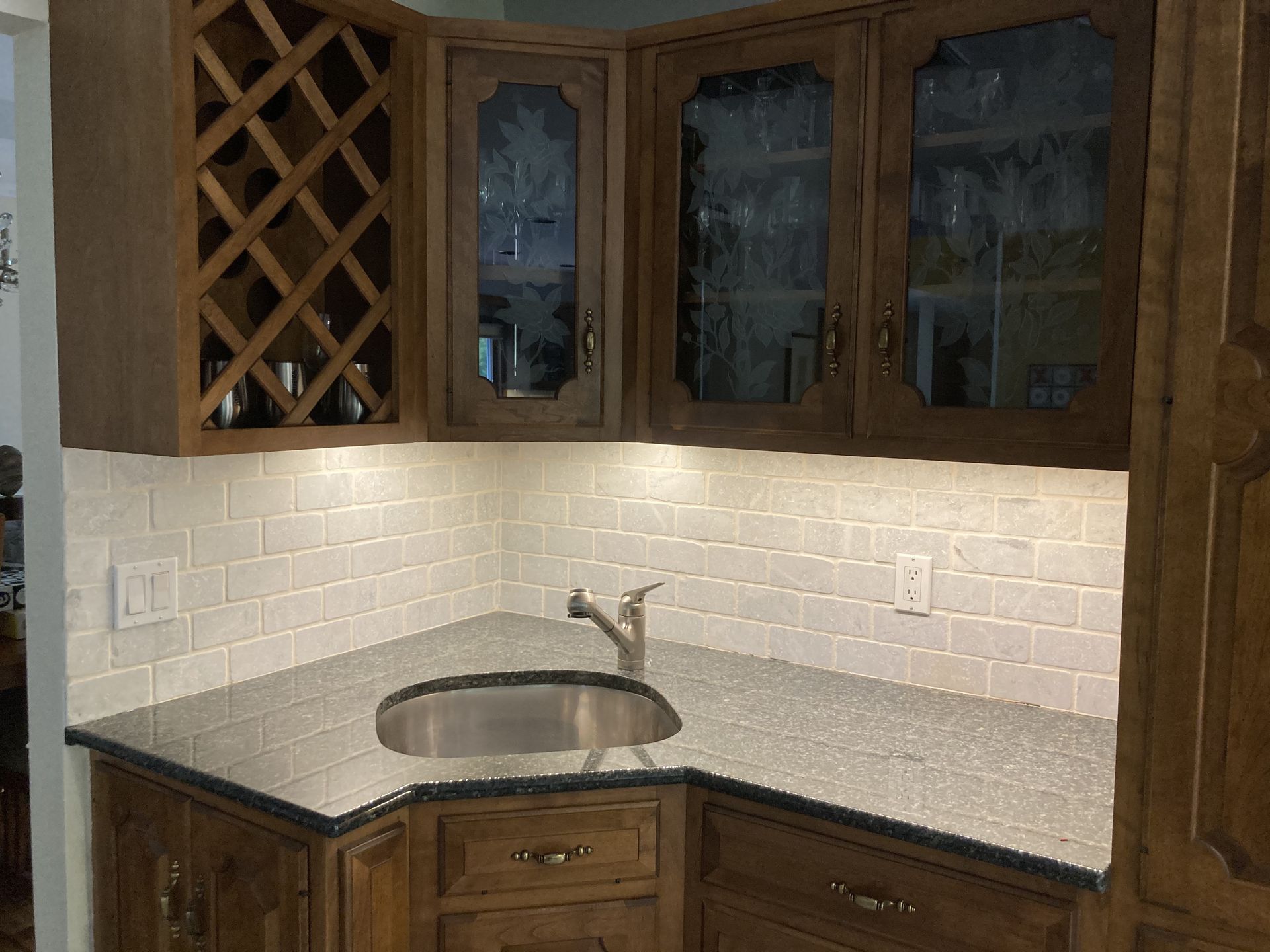 a kitchen with a wine rack above the sink