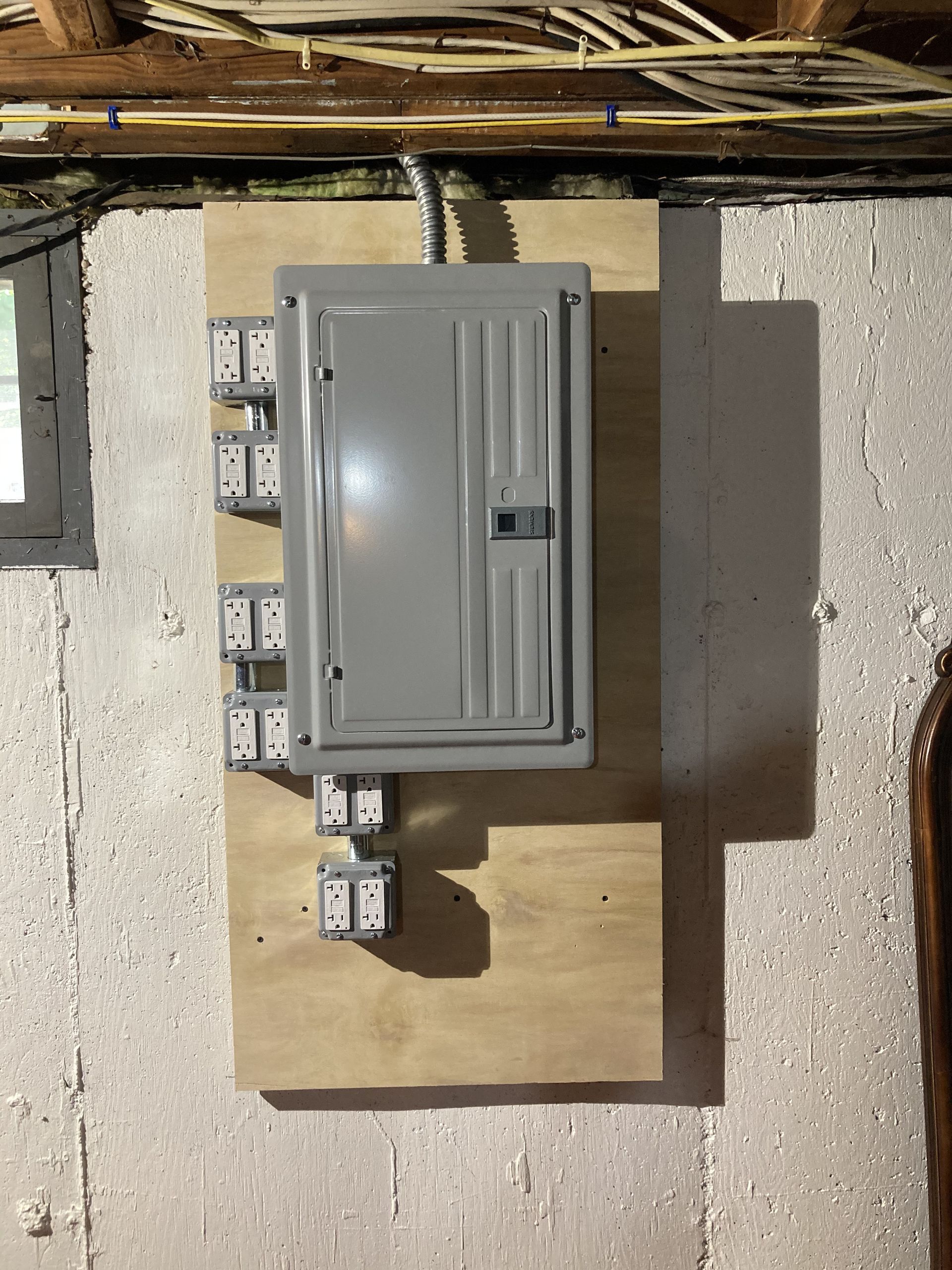an electrical box is mounted on a wooden board
