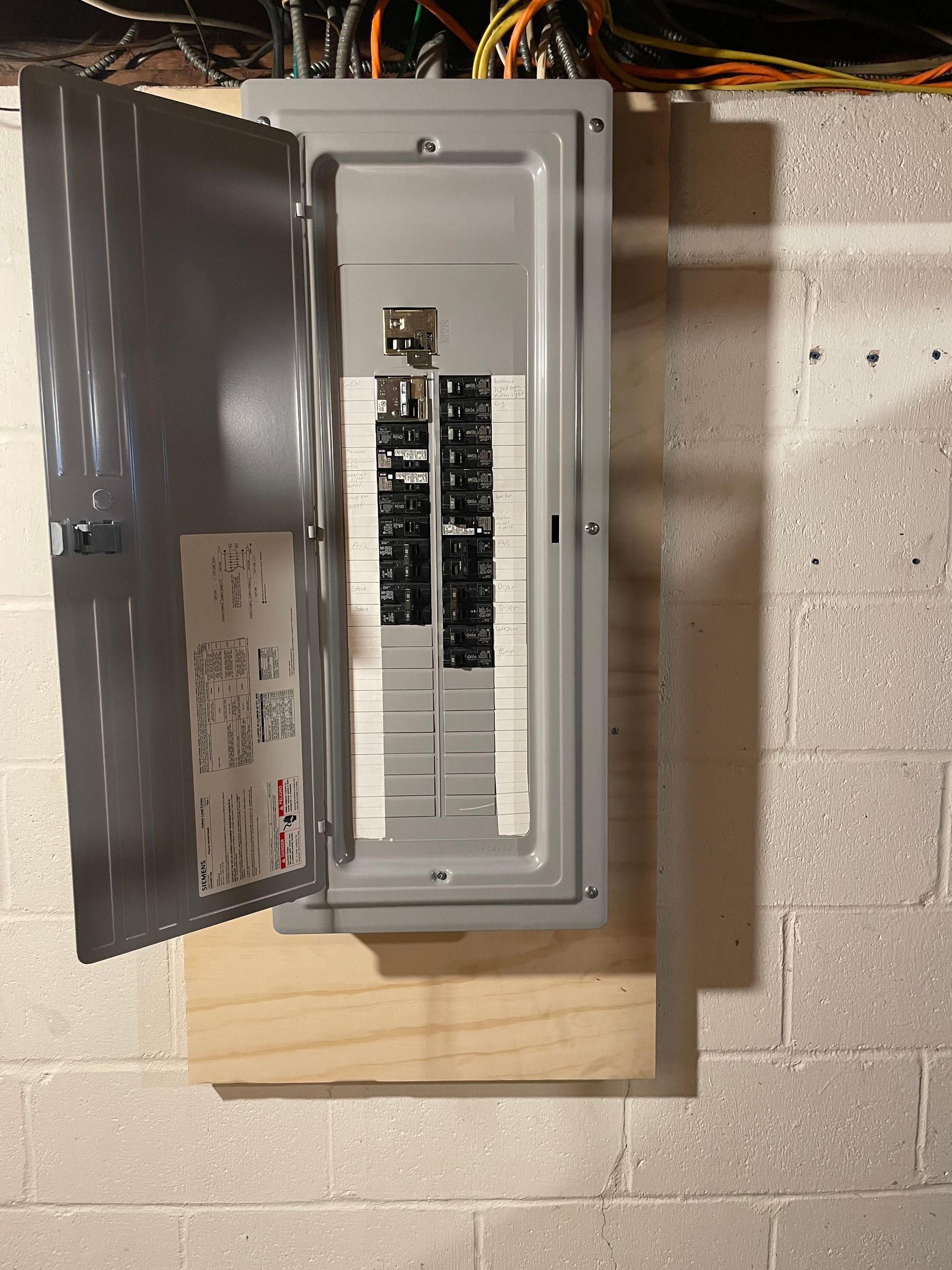 an open electrical box with a sticker on it that says 