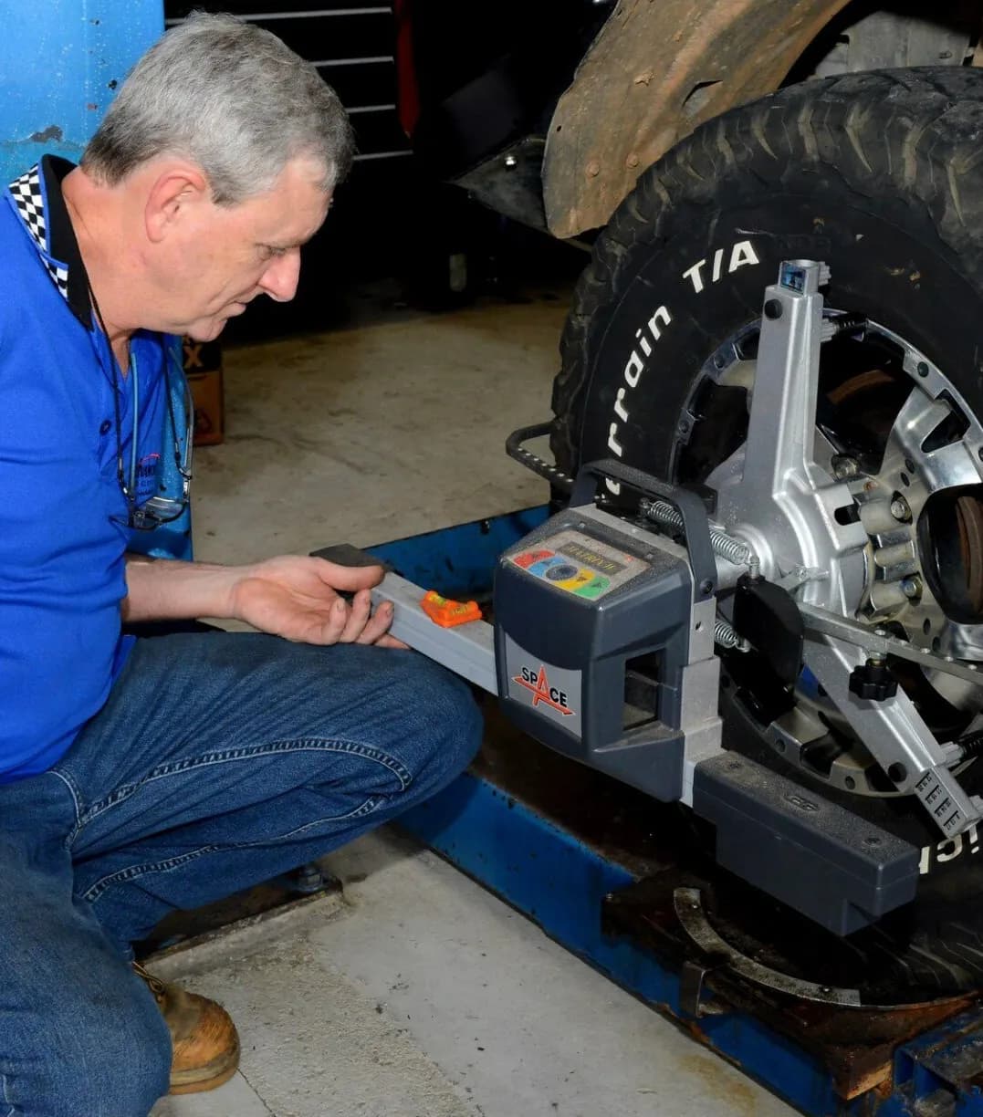 Mechanic Setting Up for Wheel Alignment — Advanced Auto Electrics & Mechanical in Innisfail, QLD
