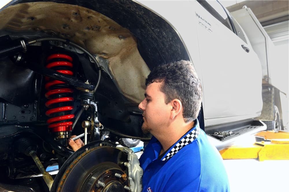 Mechanic Preparing for Wheel Alignment — Advanced Auto Electrics & Mechanical in Innisfail, QLD