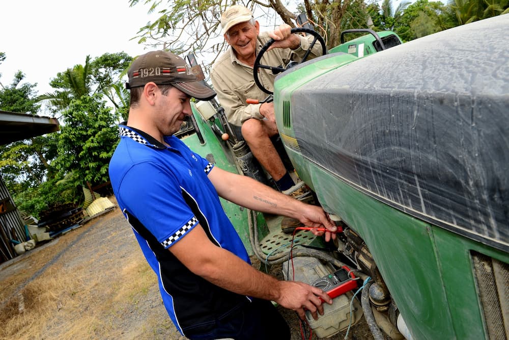 Mechanic Fixing Tractor Auto Electrics — Advanced Auto Electrics & Mechanical in Innisfail, QLD