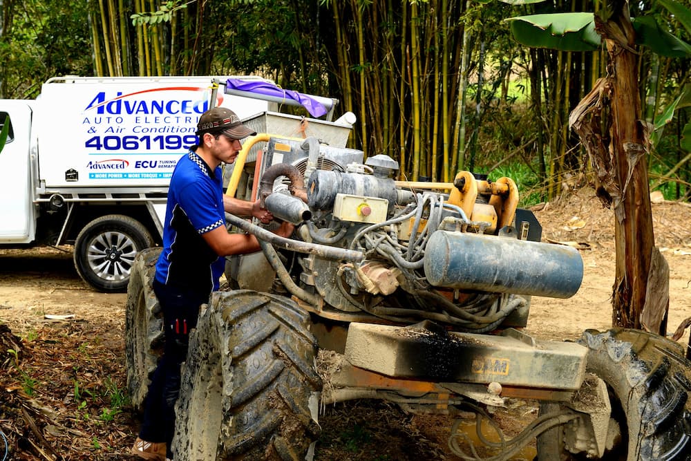 Man Fixing the Tractor's Engine — Advanced Auto Electrics & Mechanical in Mission Beach, QLD