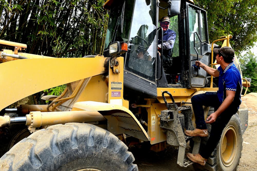 Mechanic Inspecting Tractor — Advanced Auto Electrics & Mechanical in Innisfail, QLD