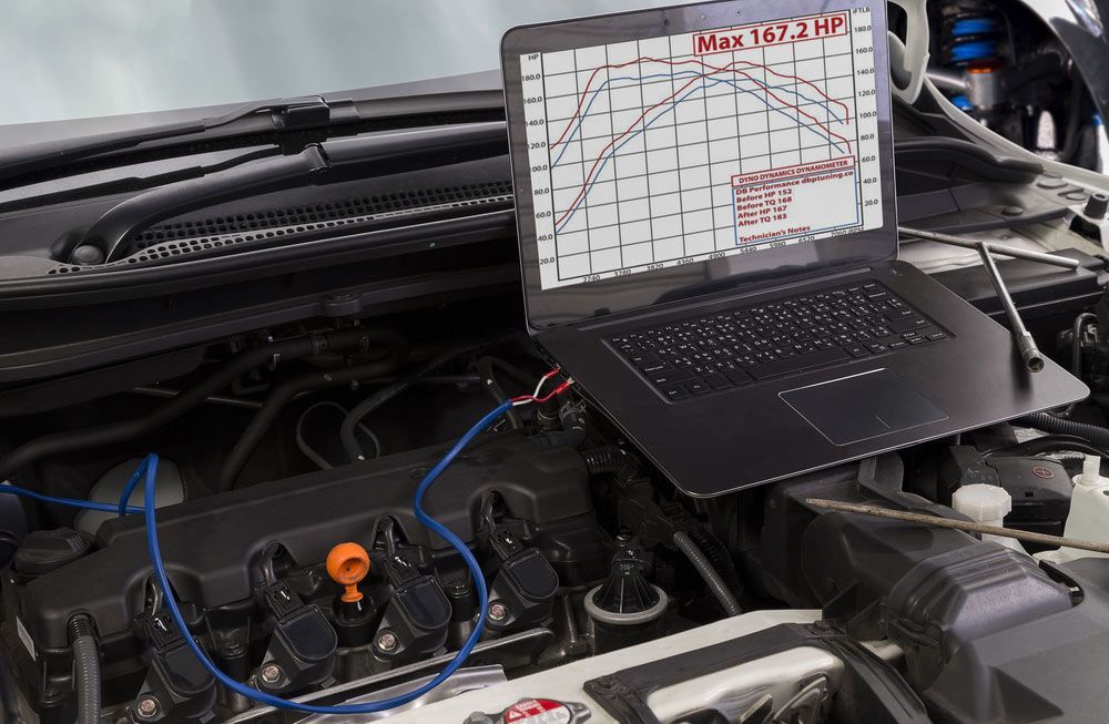 A Laptop is Sitting on Top of a Car Engine — Advance Auto Electrics & Mechanical in Innisfail, QLD