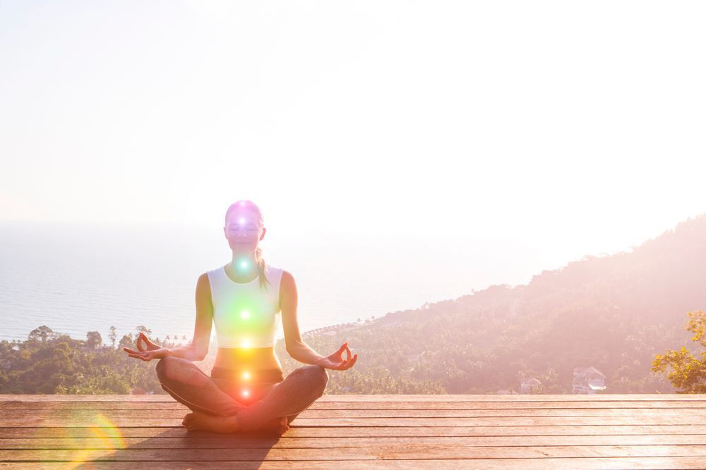 A Woman is Sitting in a Lotus Position on a Wooden Deck — Angel of Light Nick Turner In East Lismore, NSW