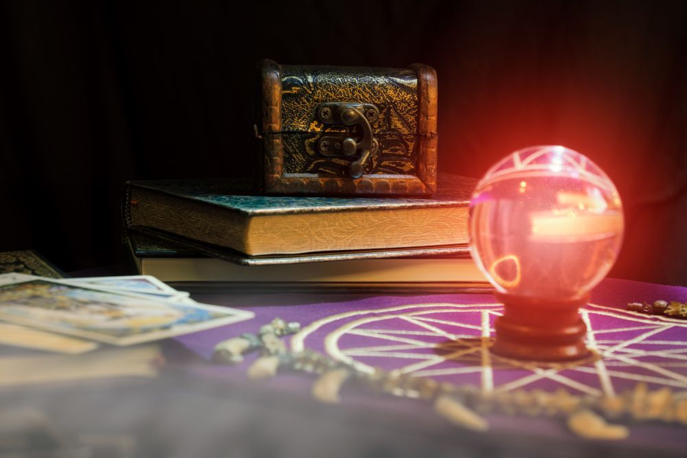 A Crystal Ball is Sitting on a Table Next to Books and Tarot Cards — Angel of Light Nick Turner In East Lismore, NSW