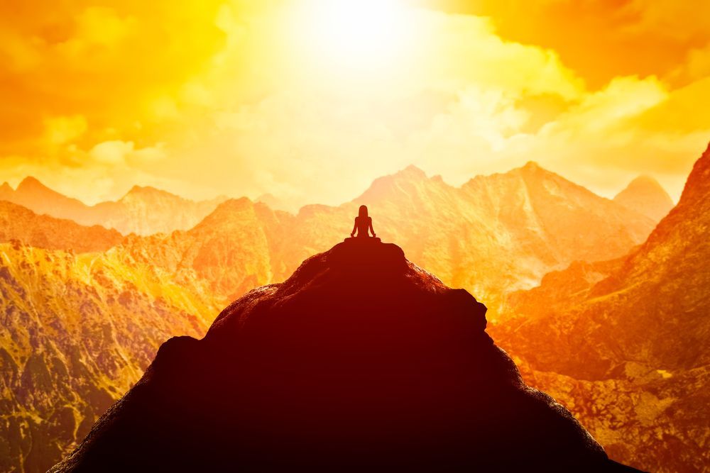 A Person is Sitting on Top of a Mountain at Sunset — Angel of Light Nick Turner In Tweed Heads, NSW