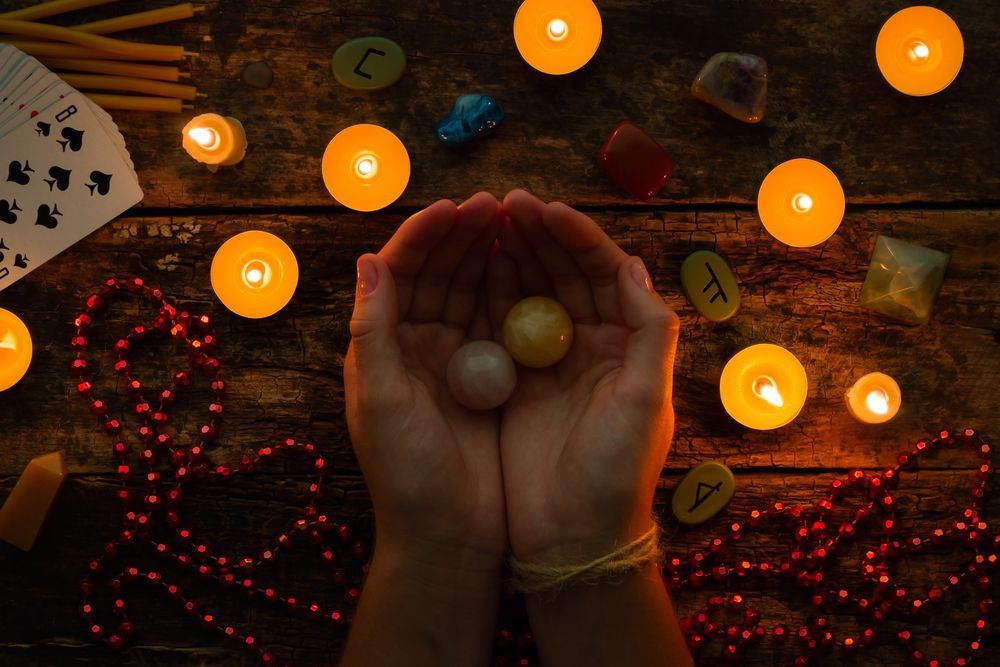 A Person is Holding a Crystal in Their Hands Surrounded by Candles — Angel of Light Nick Turner In Ballina, NSW