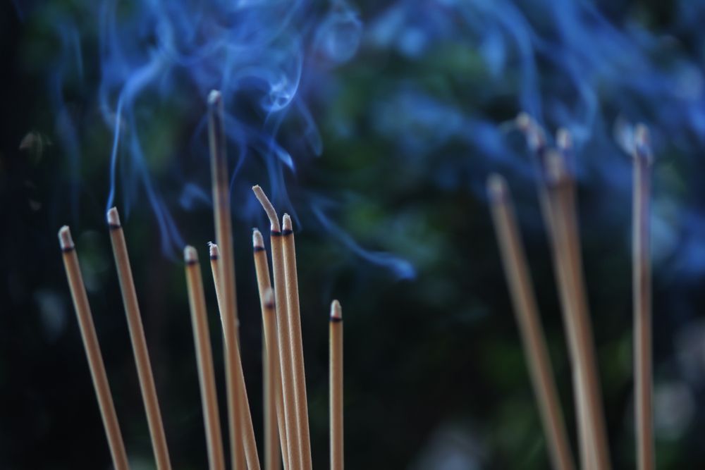 A Bunch of Incense Sticks With Blue Smoke Coming Out of Them — Angel of Light Nick Turner In Byron Bay, NSW