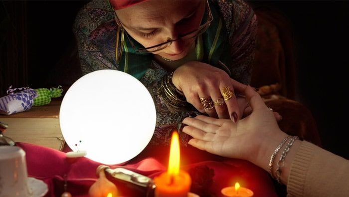 A Woman is Sitting at a Table With Candles and a Crystal Ball — Angel of Light Nick Turner In East Lismore, NSW