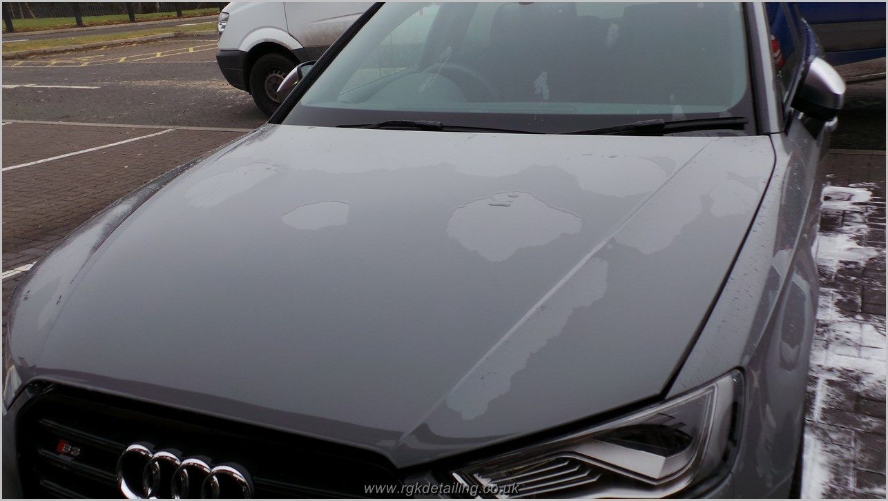 A gray audi a3 is parked in a parking lot.