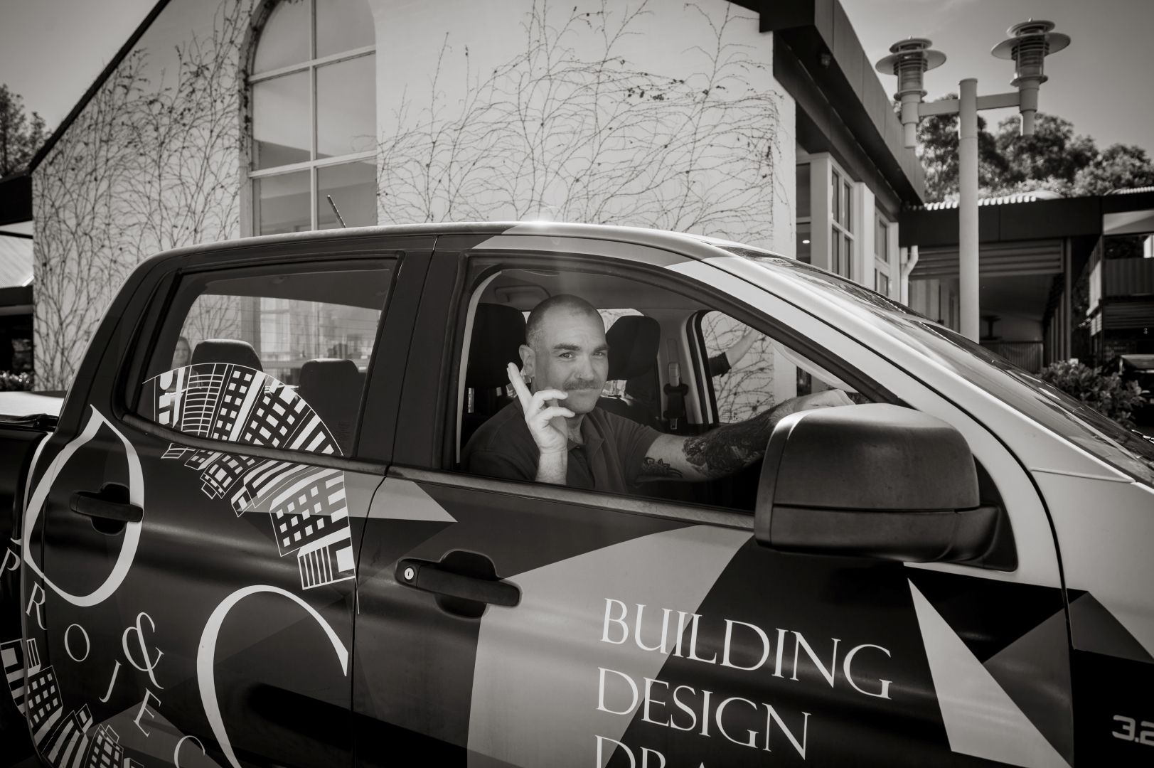 Industrial Building Exterior With Colourful Door Frames — D&C Projects in Tamworth, NSW