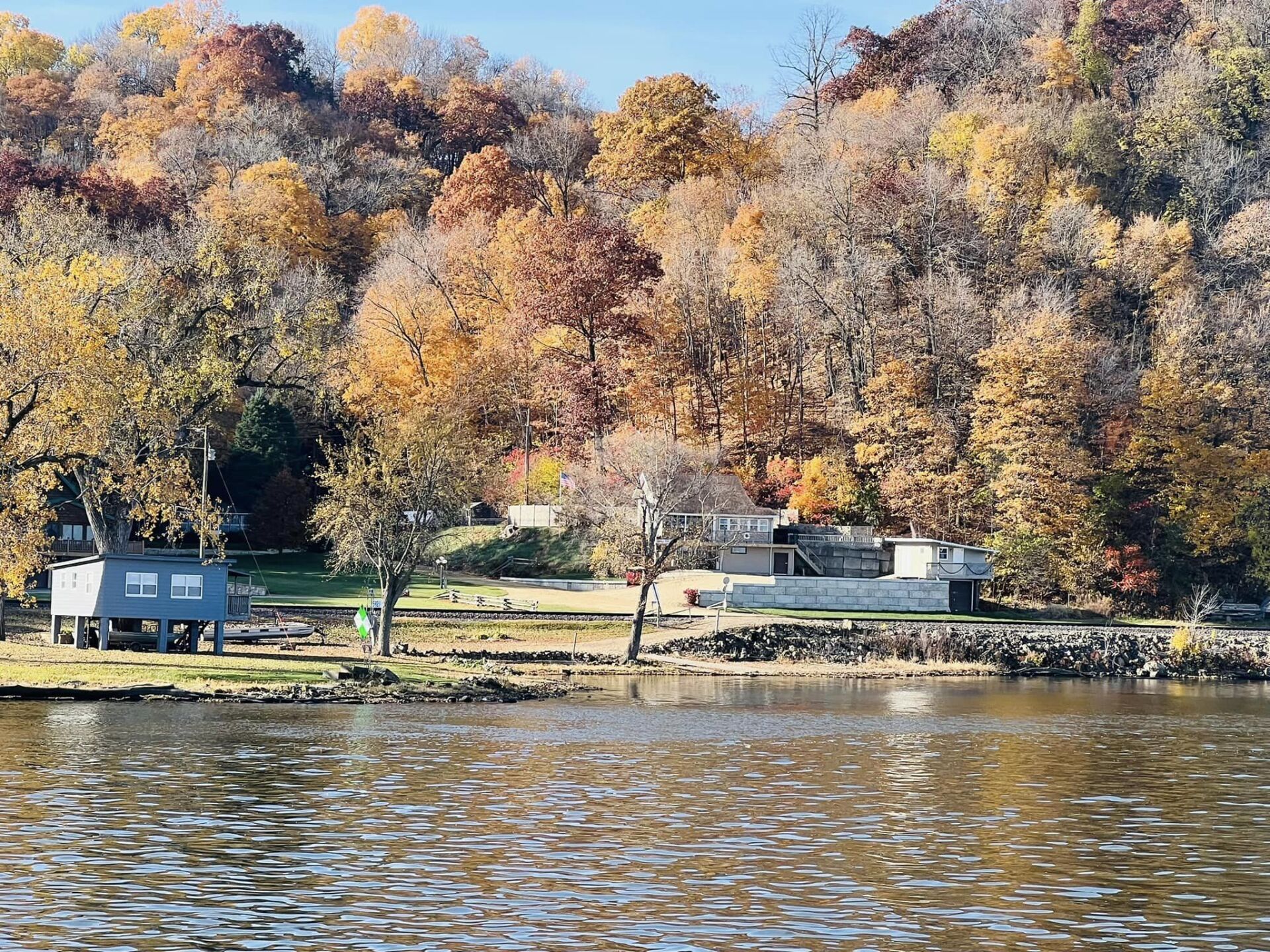 a small island in the middle of a lake with trees in the background .