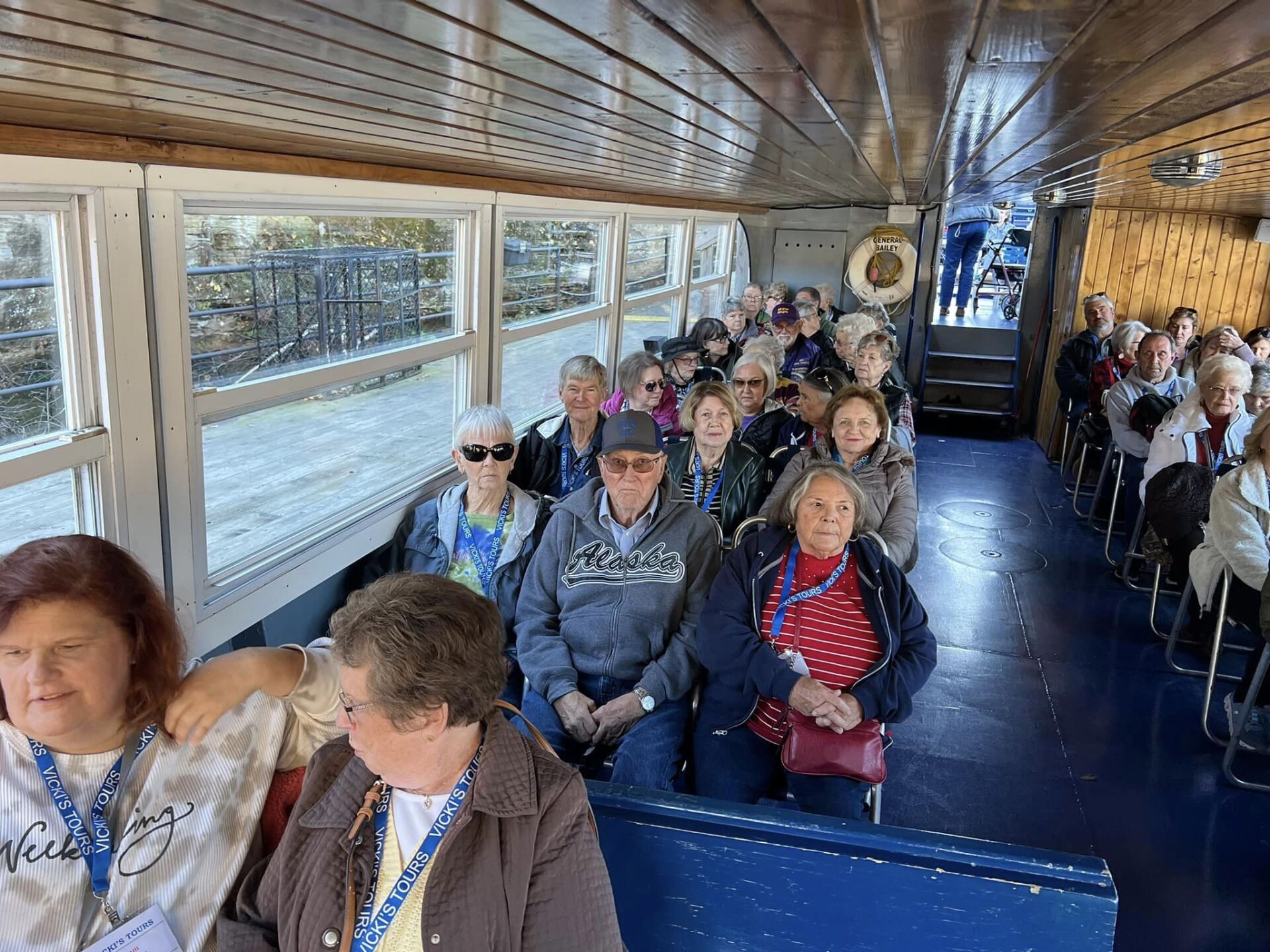 a group of people are sitting on a boat .