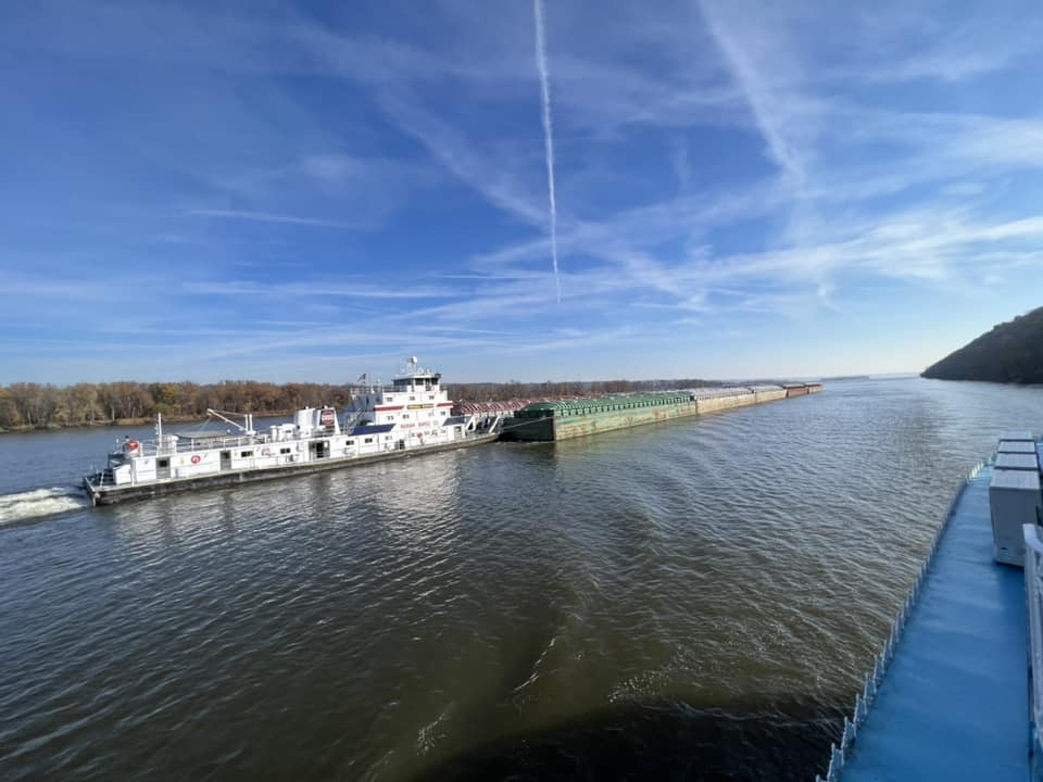 a large ship is floating on top of a large body of water .