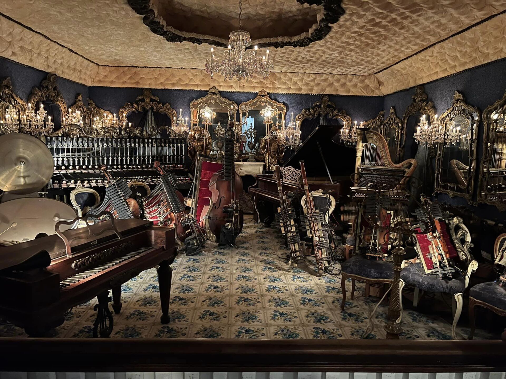 a room filled with lots of musical instruments and a piano