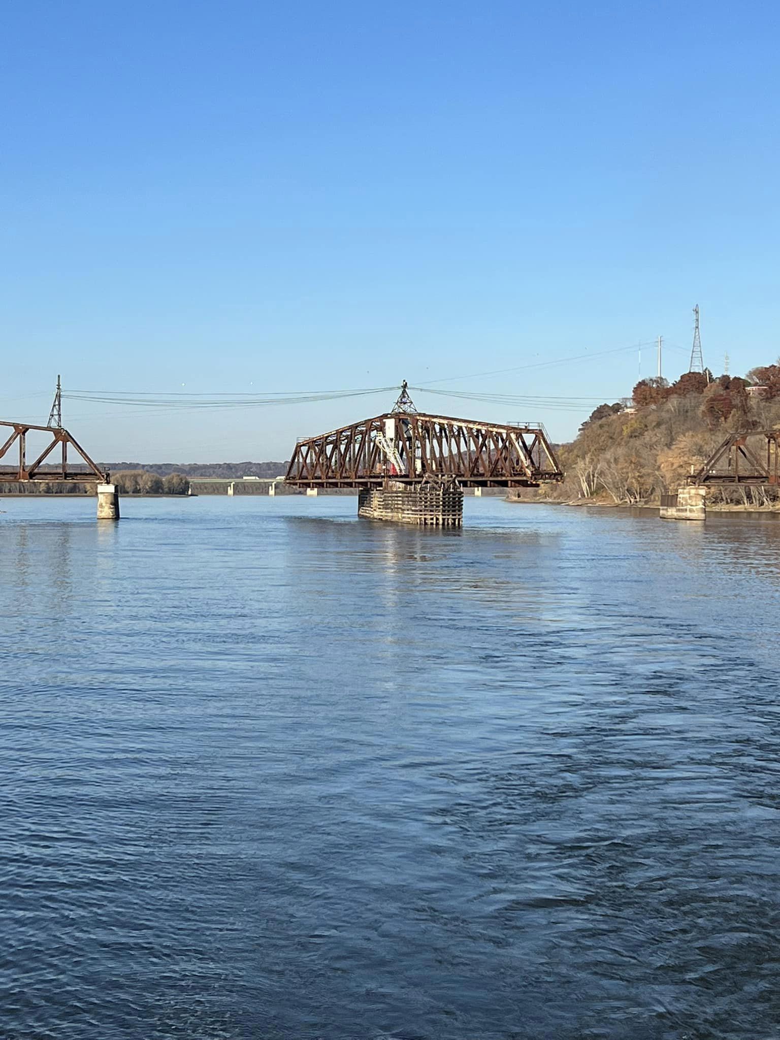 a bridge over a body of water with a blue sky in the background