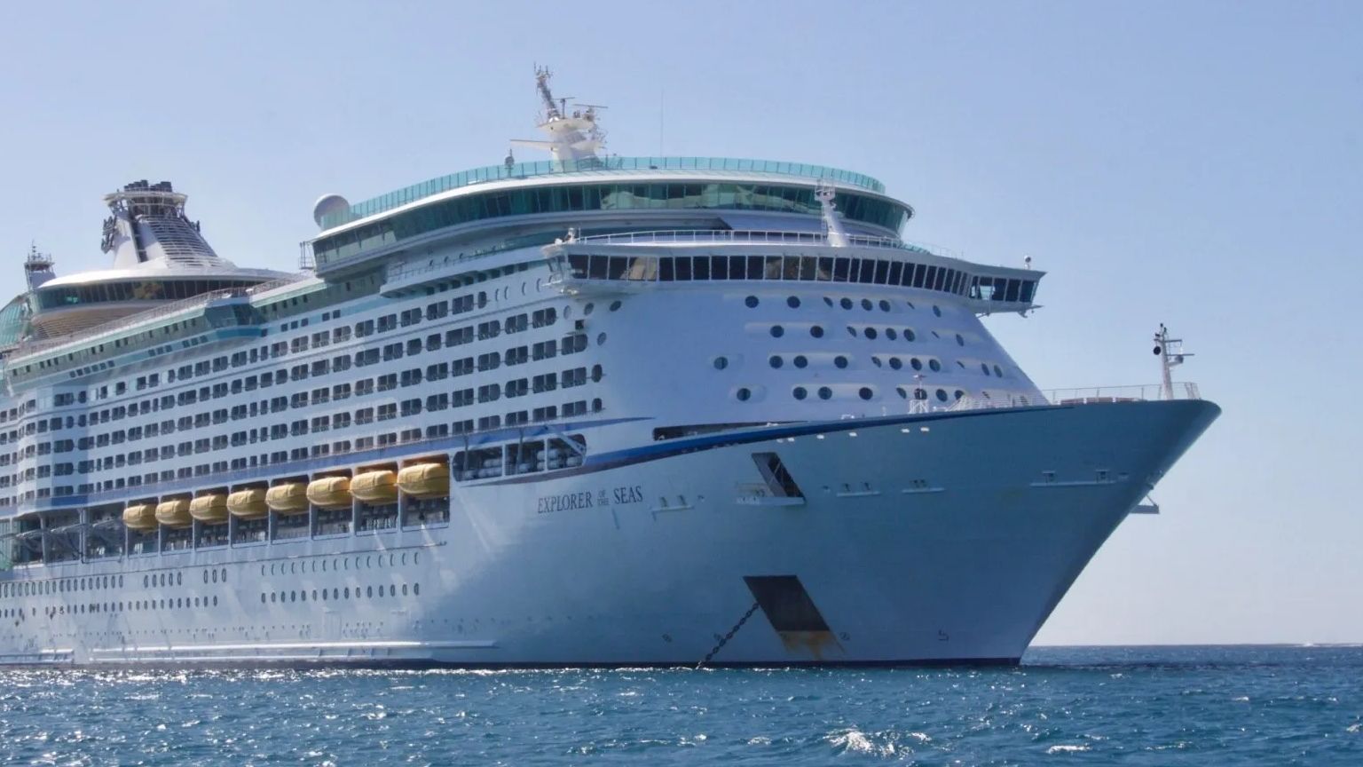a large cruise ship is floating in the ocean