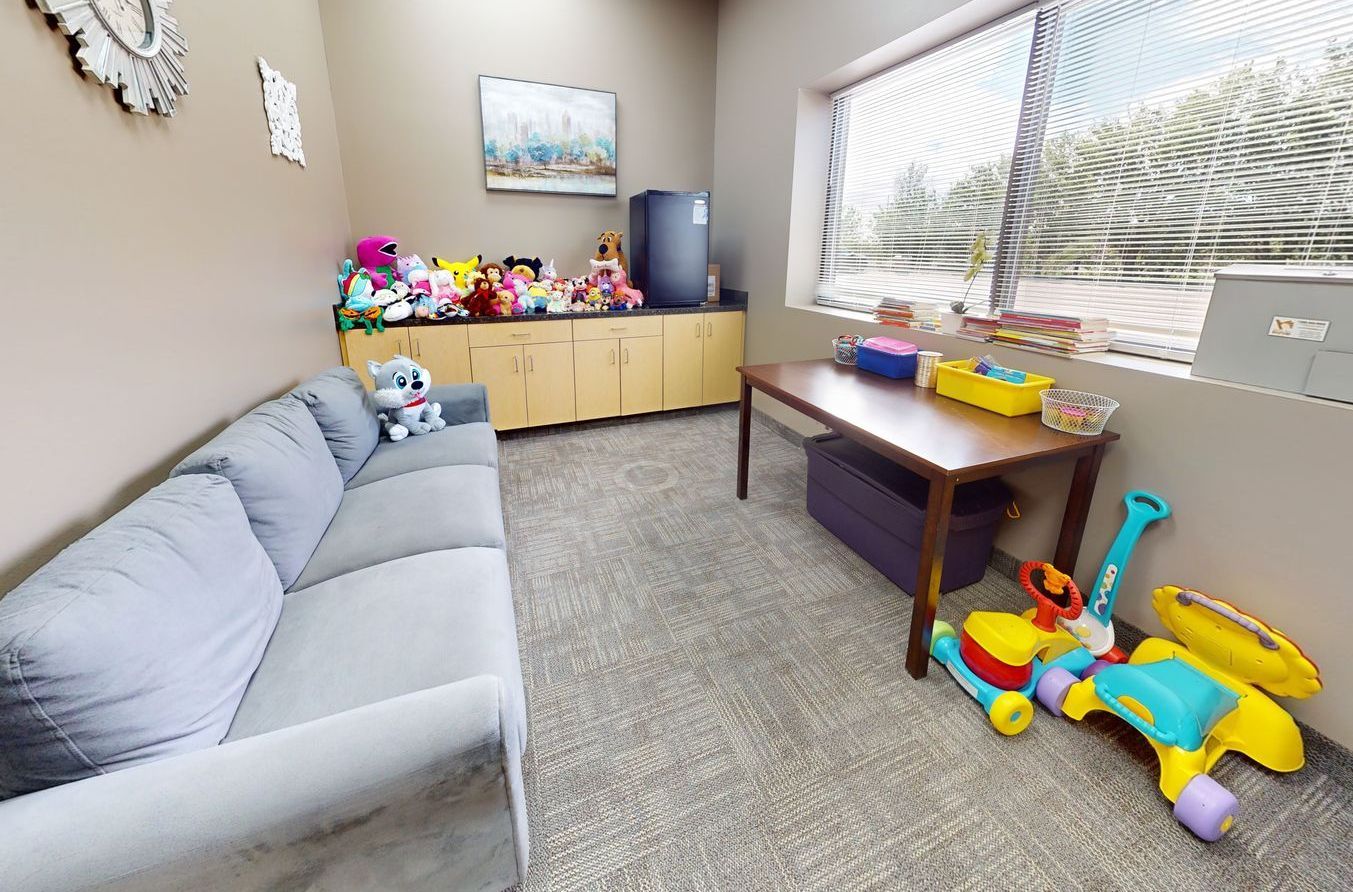 A living room with a couch , table , and toys.