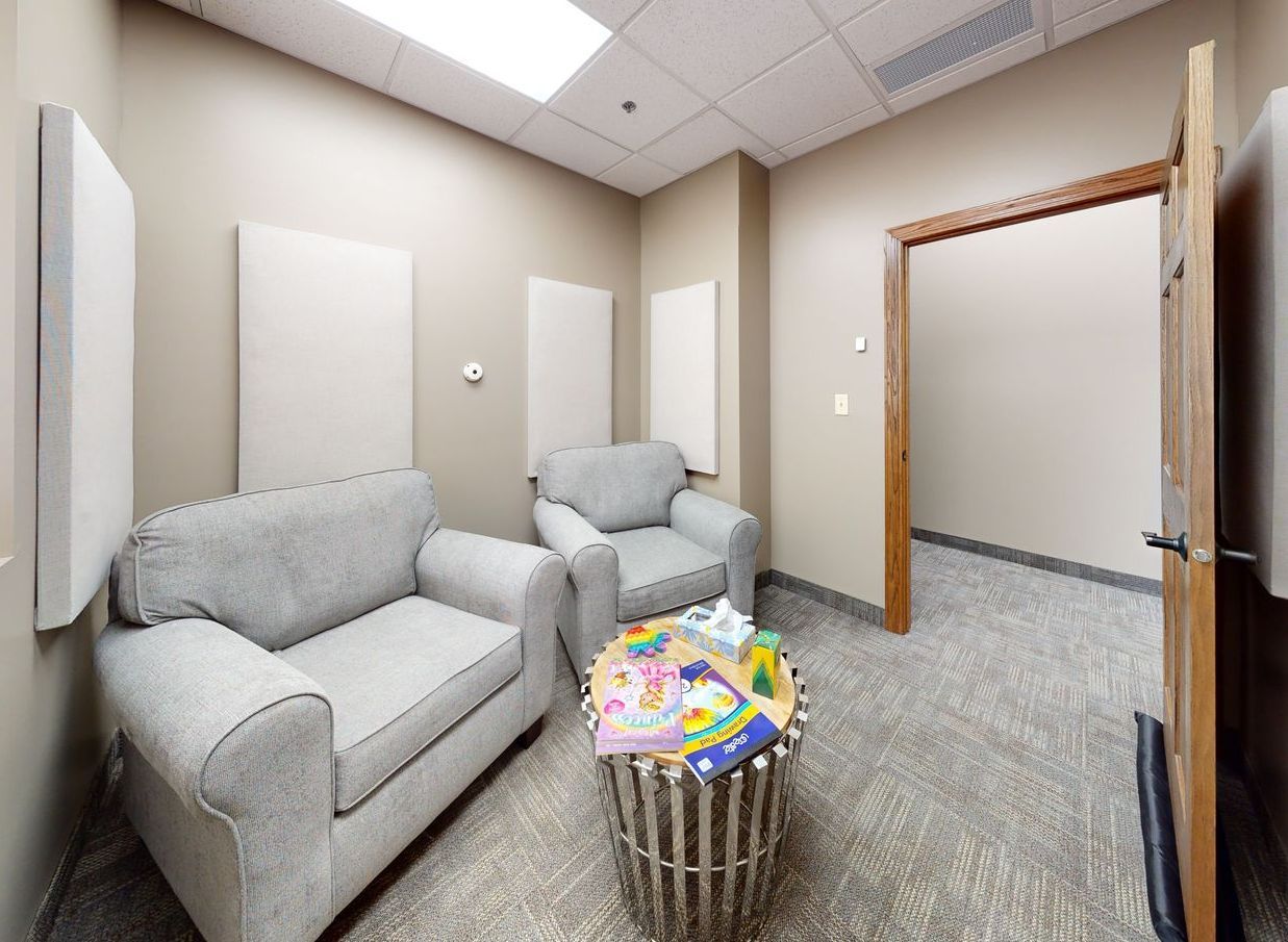 There are two chairs and a table in the room.