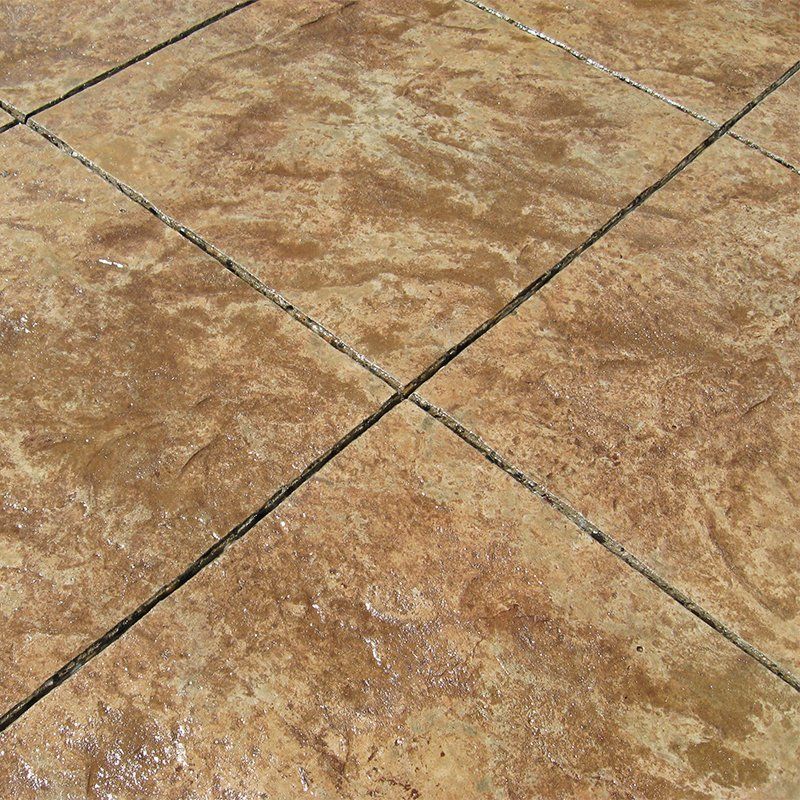 A close up of a concrete floor with a tile pattern