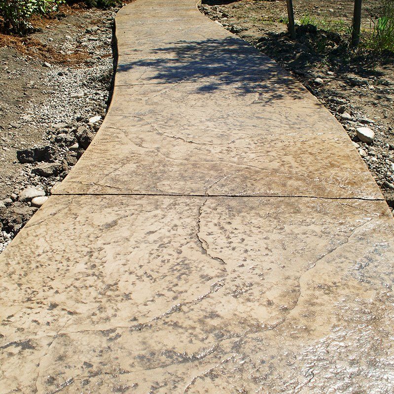 A concrete walkway with a swirl in the middle