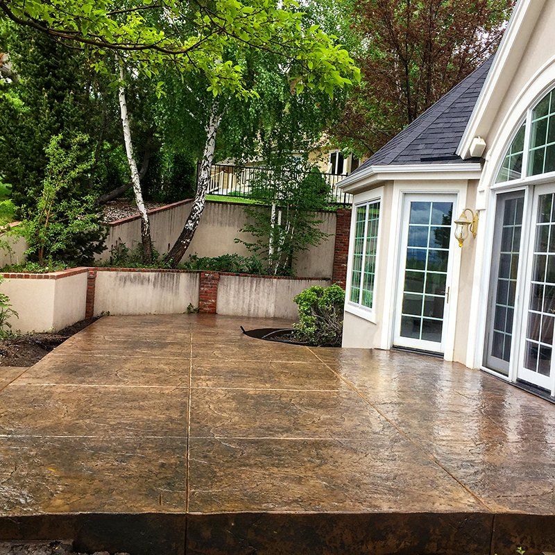 A patio in front of a house with a lot of windows