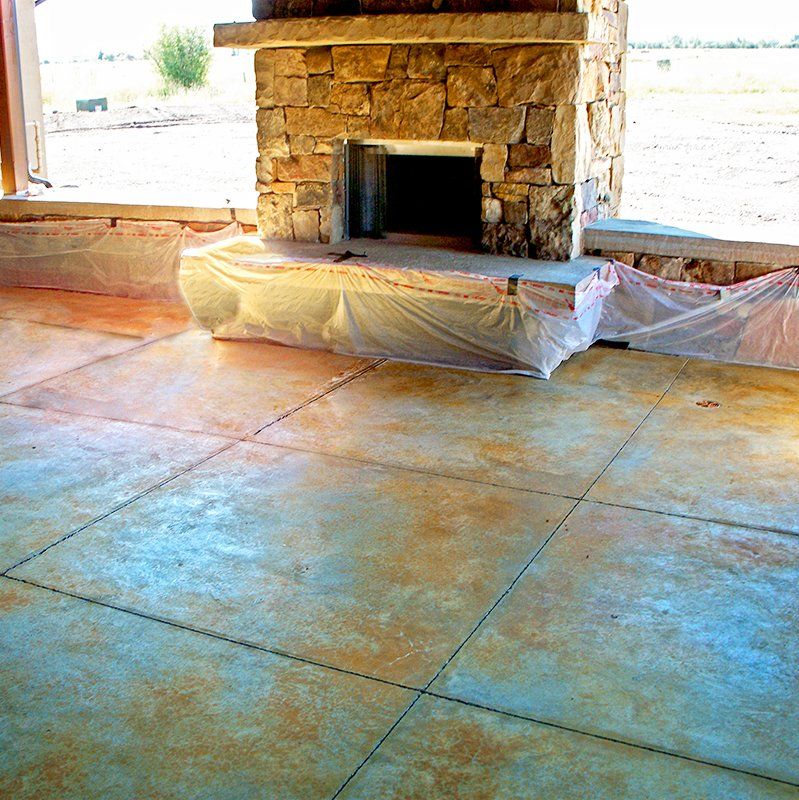 A stone fireplace in a room with a tiled floor