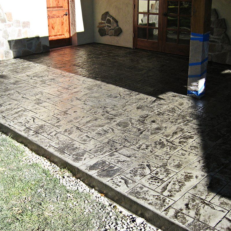 A concrete walkway with a shadow of a person on it