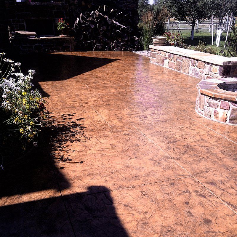 A patio with a fire pit in the middle of it