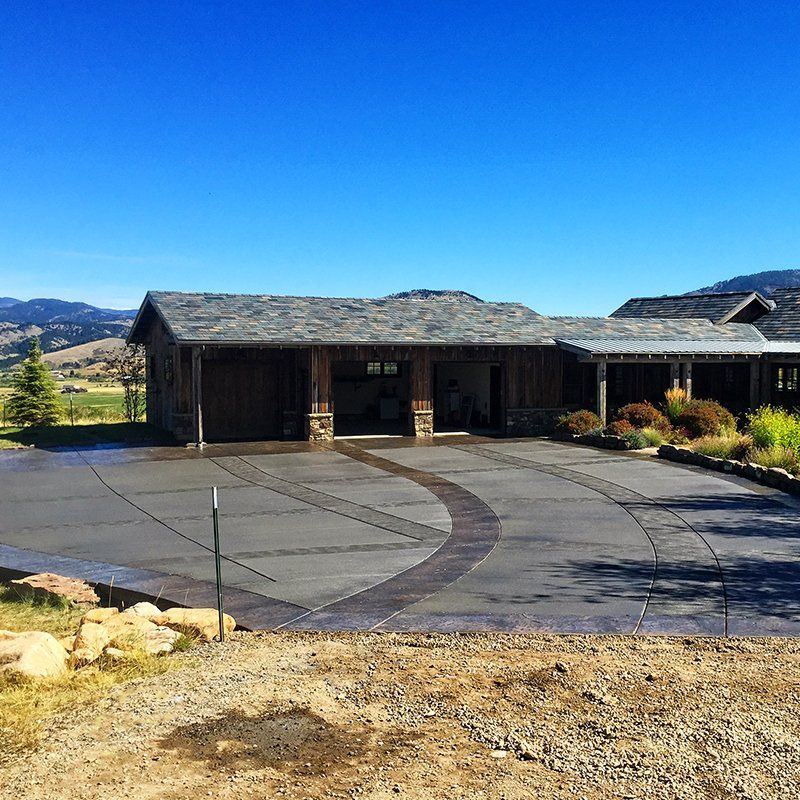A large house with a large driveway in front of it
