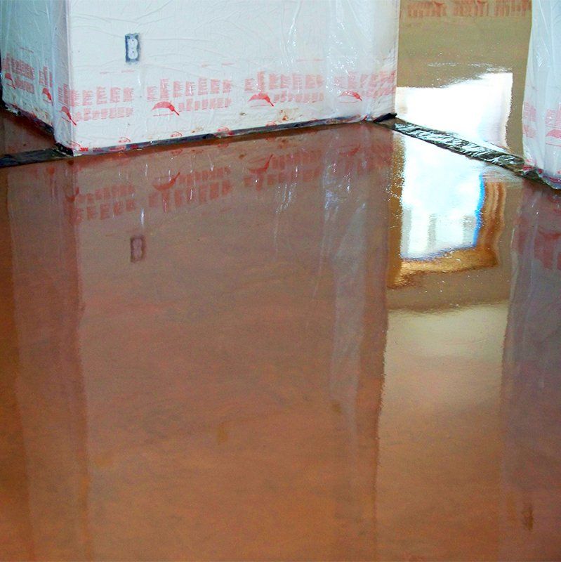 A copper floor with a reflection of a window in it.