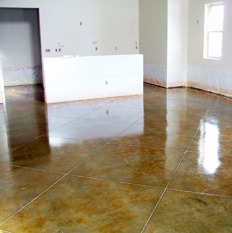 A room with a shiny concrete floor and white walls.