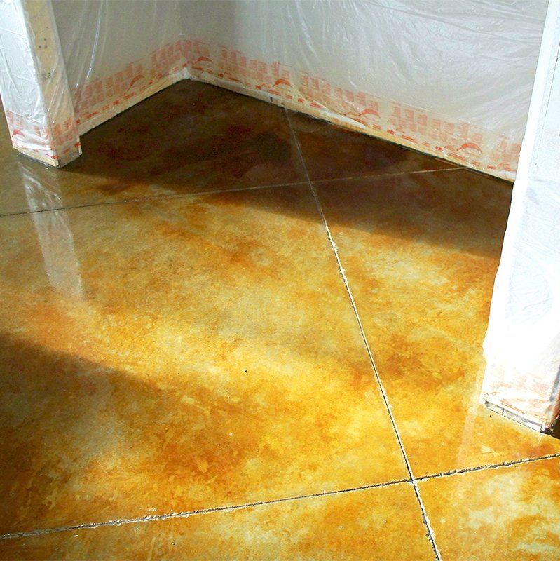 A corner of a room with a concrete floor