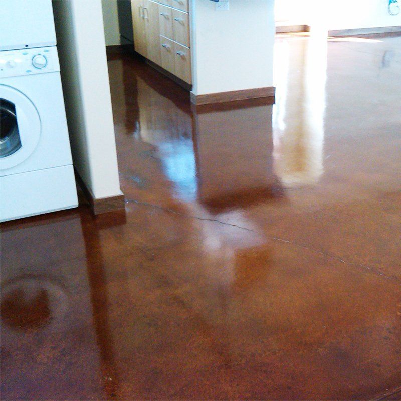 A kitchen with a washer and dryer on the floor