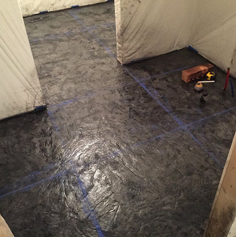 A black concrete floor with blue lines on it